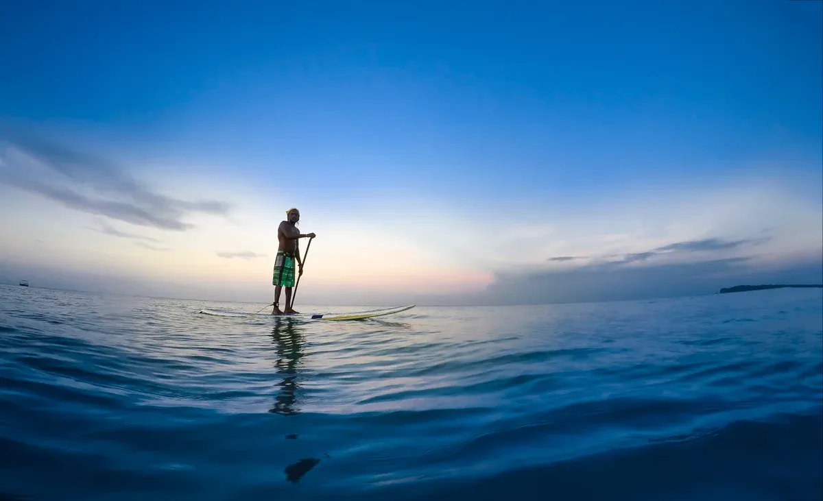 Paddleboarder on the bay at Trincomalee, the east coast alternative to Mirissa whale watching tours, Sri Lanka